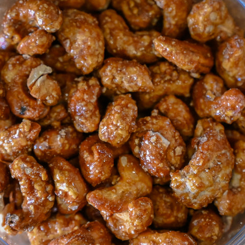 Close-up of glazed butter-toasted cashews filling the frame.