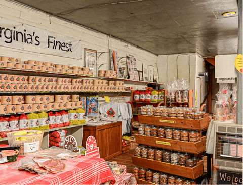 Store interior with shelves stocked with products and a sign reading 'Virginia's Finest'.