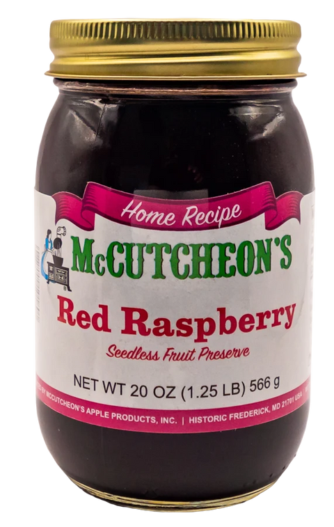 A 20 oz glass jar of McCutcheon's Red Raspberry Seedless Fruit Preserve with a gold metal lid and a white label, isolated on a white background.