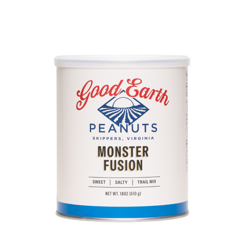 A white cylindrical canister of Good Earth Peanuts Monster Fusion trail mix, featuring a white label with red and blue branding and a blue band at the bottom, set against a plain white background.