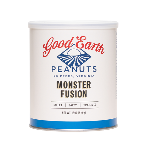 A white cylindrical canister of Good Earth Peanuts Monster Fusion trail mix, featuring a white label with red and blue branding and a blue band at the bottom, set against a plain white background.