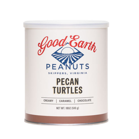 A canister of Good Earth Peanuts Pecan Turtles on a solid white background. The canister is off-white with a white lid, featuring the brand logo in red and blue, and the product name 'Pecan Turtles' in dark brown text.